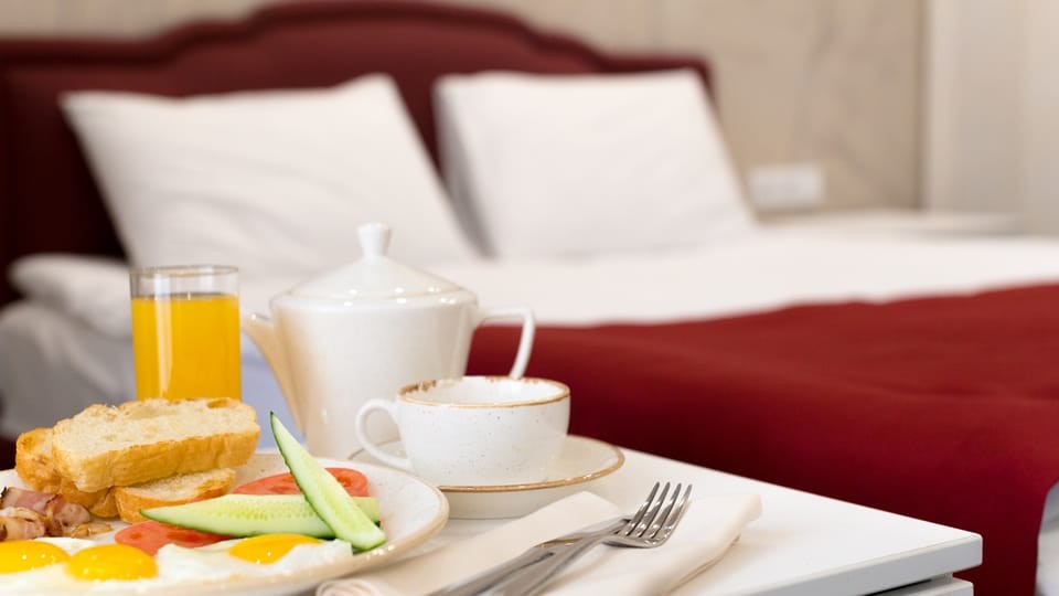 Breakfast in bed in hotel room